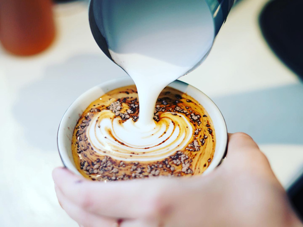 pouring milk over coffee at Corner Counter, Mornington Peninsula