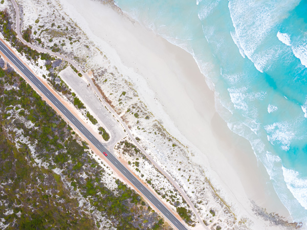 A car driving along the coast in Esperance, WA