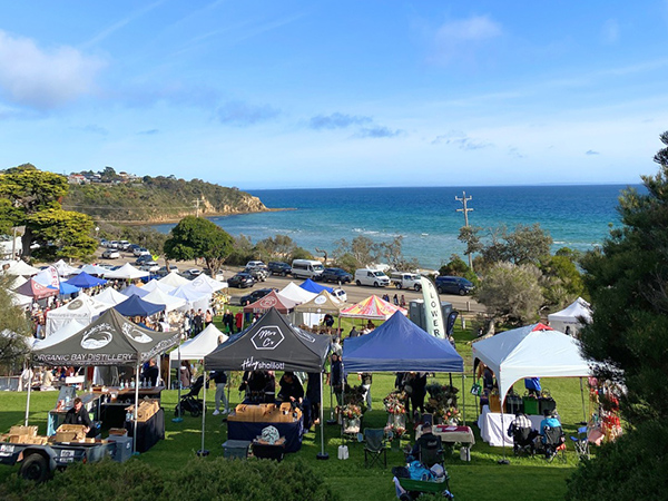 Stalls at Mount Martha Briars Market and a view of the beach.