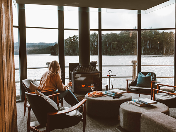 A woman looking at a big wind in Pumphouse Point with the view of Lake St. Clair.