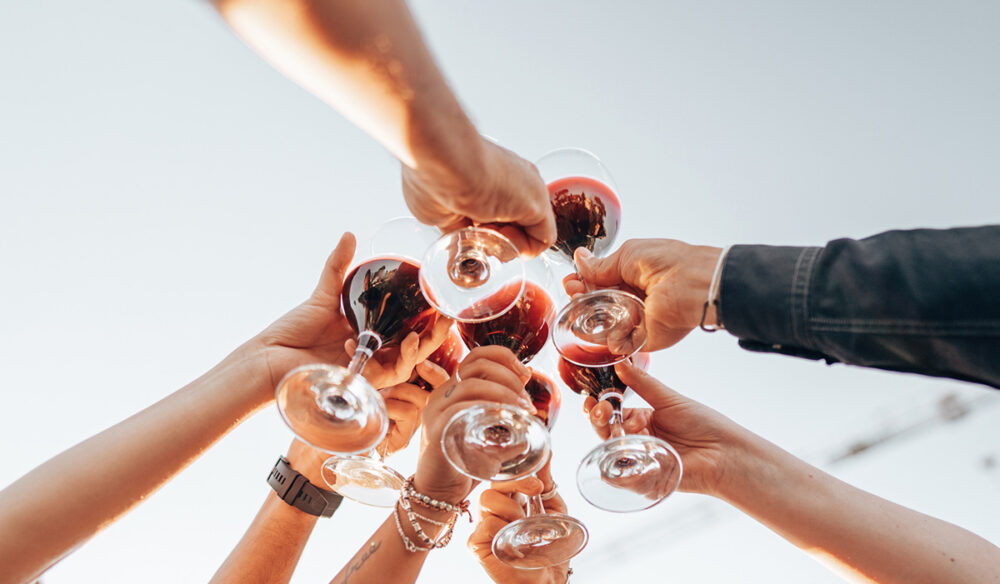 friends holding their wine in the air