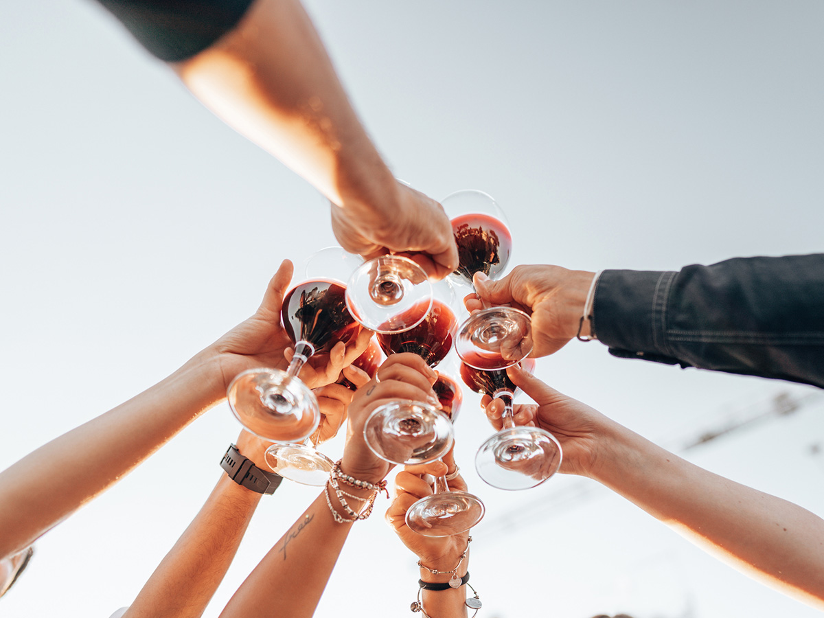 friends holding their wine in the air