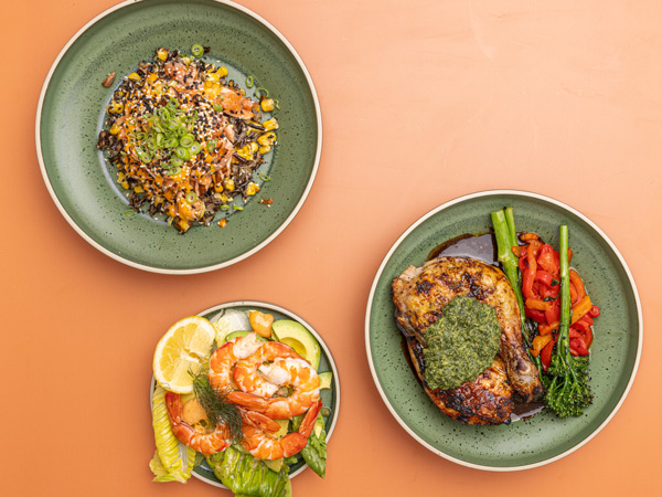 three plates of food on orange background at Coogee Bay Hotel
