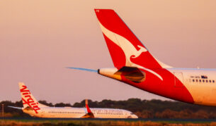 Qantas and Virgin planes on an airport runway