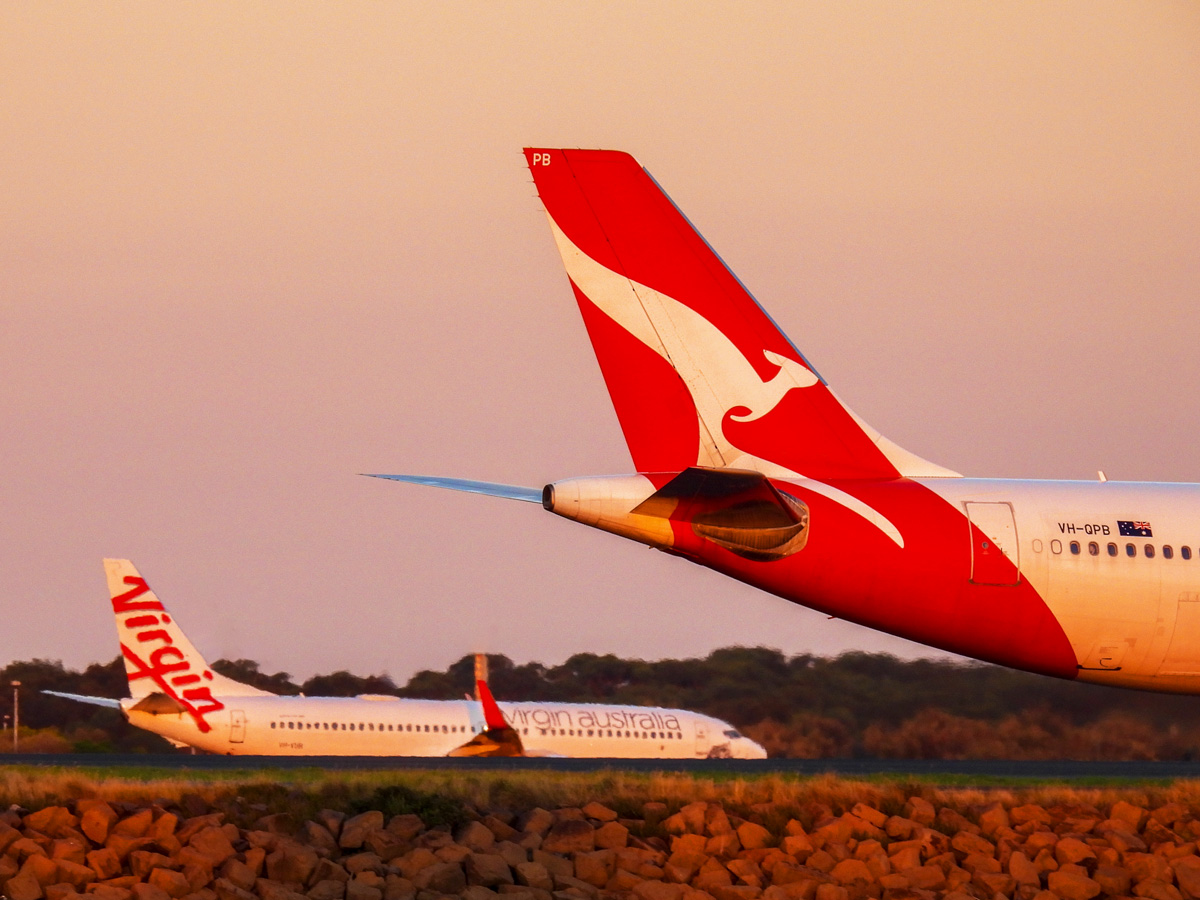 Qantas and Virgin planes on an airport runway