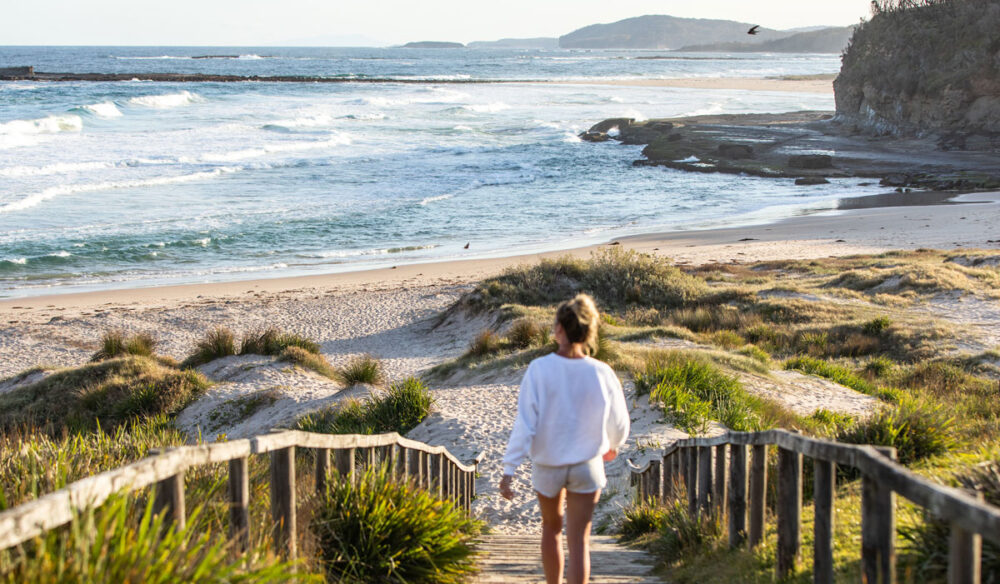 a woman walking to the shore, Pretty Beach, Shoalhaven