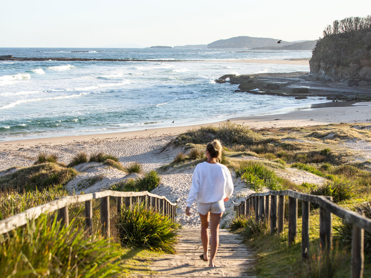 a woman walking to the shore, Pretty Beach, Shoalhaven