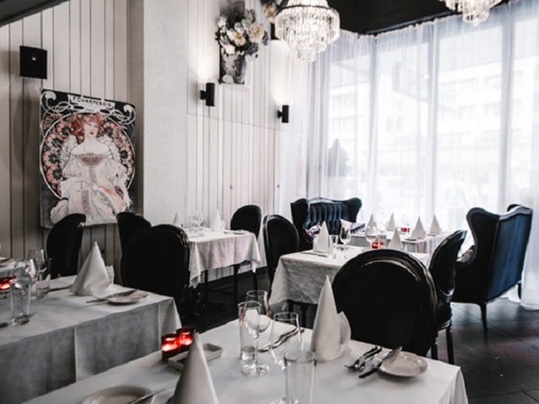 a classic black and white French dining interior at Claire's Kitchen