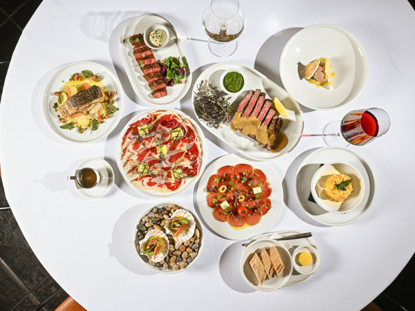 a spread of food on a white table at Beckett’s Bar + Dining, Paddington