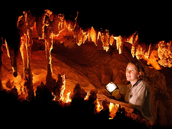 woman exploring the Capricorn Caves in queensland