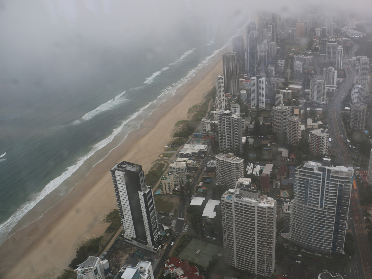 View south along the Gold Coast, from Broadbeach cityscape through window of high observation point on stormy, overcast afternoon