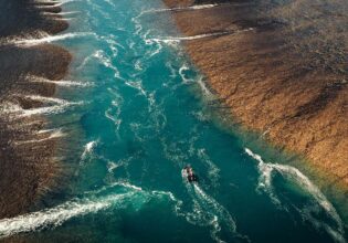 aerial view of boat going along Montgomery Reef