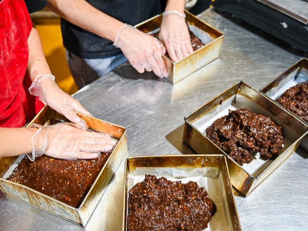 hands kneading bread at Brickfields Bakery, Chippendale
