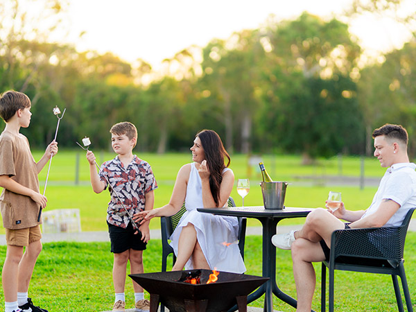 Family having a drink and toasting marshmallows 