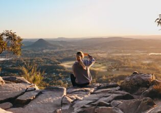 woman enjoying the view after hiking through Noosa National Park, noosa in winter
