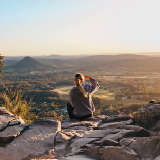 woman enjoying the view after hiking through Noosa National Park, noosa in winter