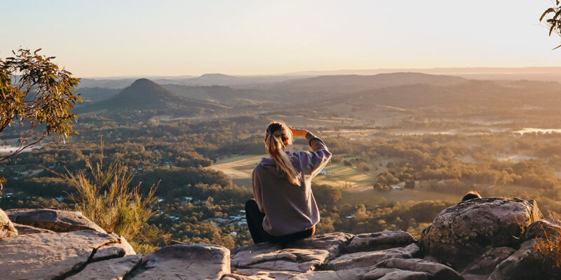 woman enjoying the view after hiking through Noosa National Park, noosa in winter