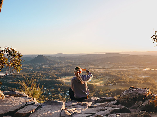 woman enjoying the view after hiking through Noosa National Park, noosa in winter