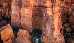 A couple stands over a waterhole in the Dampier Peninsula WA