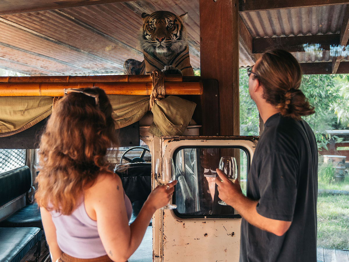 a couple holding wine on the Taronga Zoo wine safari sydney