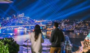 A couple watching the lights of Vivid Sydney at Aster, InterContinental Sydney