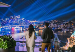 A couple watching the lights of Vivid Sydney at Aster, InterContinental Sydney