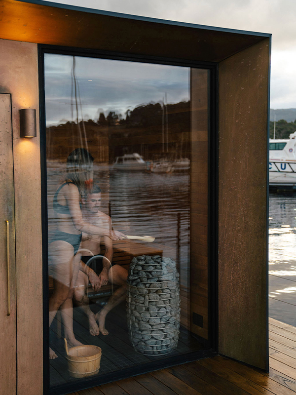 A couple sitting in a floating sauna.