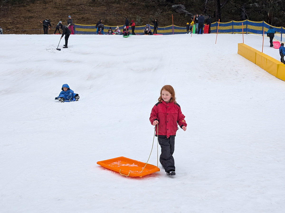 Young girl at Corin Forest with toboggan