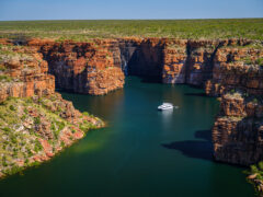 A Kimberley cruise drifts beneath King George Falls, where sheer sandstone cliffs frame the thunderous plunge into turquoise waters. Discover the best of Australia's North West cruises.