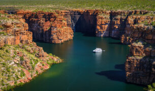 A Kimberley cruise drifts beneath King George Falls, where sheer sandstone cliffs frame the thunderous plunge into turquoise waters. Discover the best of Australia's North West cruises.