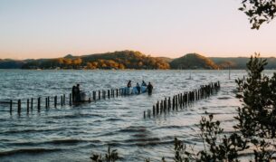 People wading in the water at Sydney Rock Oysters in-water dining experience