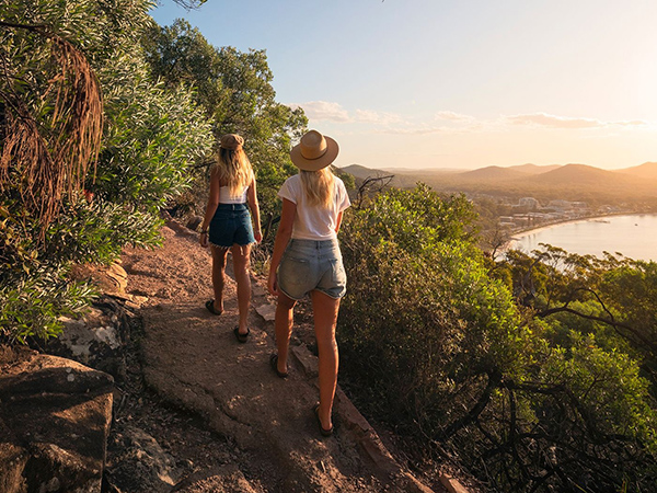 Friends enjoying a scenic walk along the Tomaree Head Summit Walk in Tomaree National Park, Port Stephens.