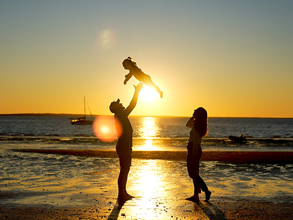 a family enjoying the sunset in front of kingfisher bay resort on k'gar fraser island