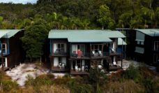 kassia standing on resort room balcony at kingfisher bay resort on k'gari