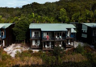 kassia standing on resort room balcony at kingfisher bay resort on k'gari