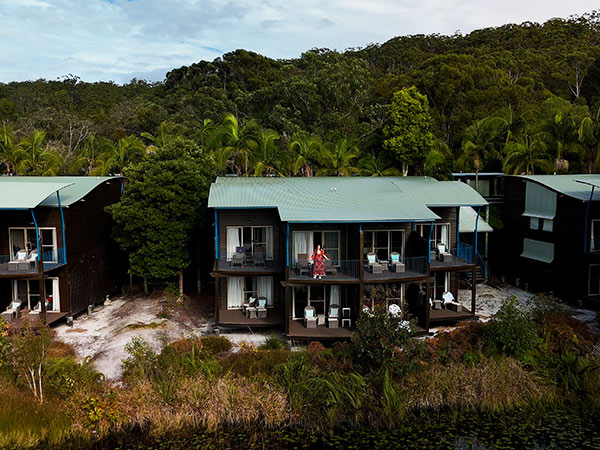 kassia standing on resort room balcony at kingfisher bay resort on k'gari