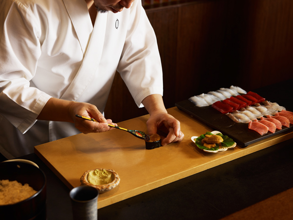 the sushi master at Omakase preparing nigiri
