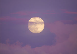 A full moon during sunset