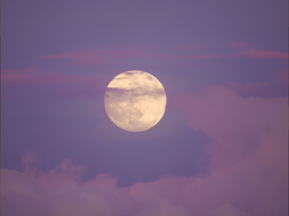 A full moon during sunset